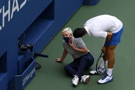 Novak Djokovic apologises to and checks to see if the line judge is okay
