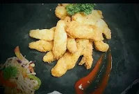 Garnished fish fingers with sprouts salad and sauce for fish finger recipe