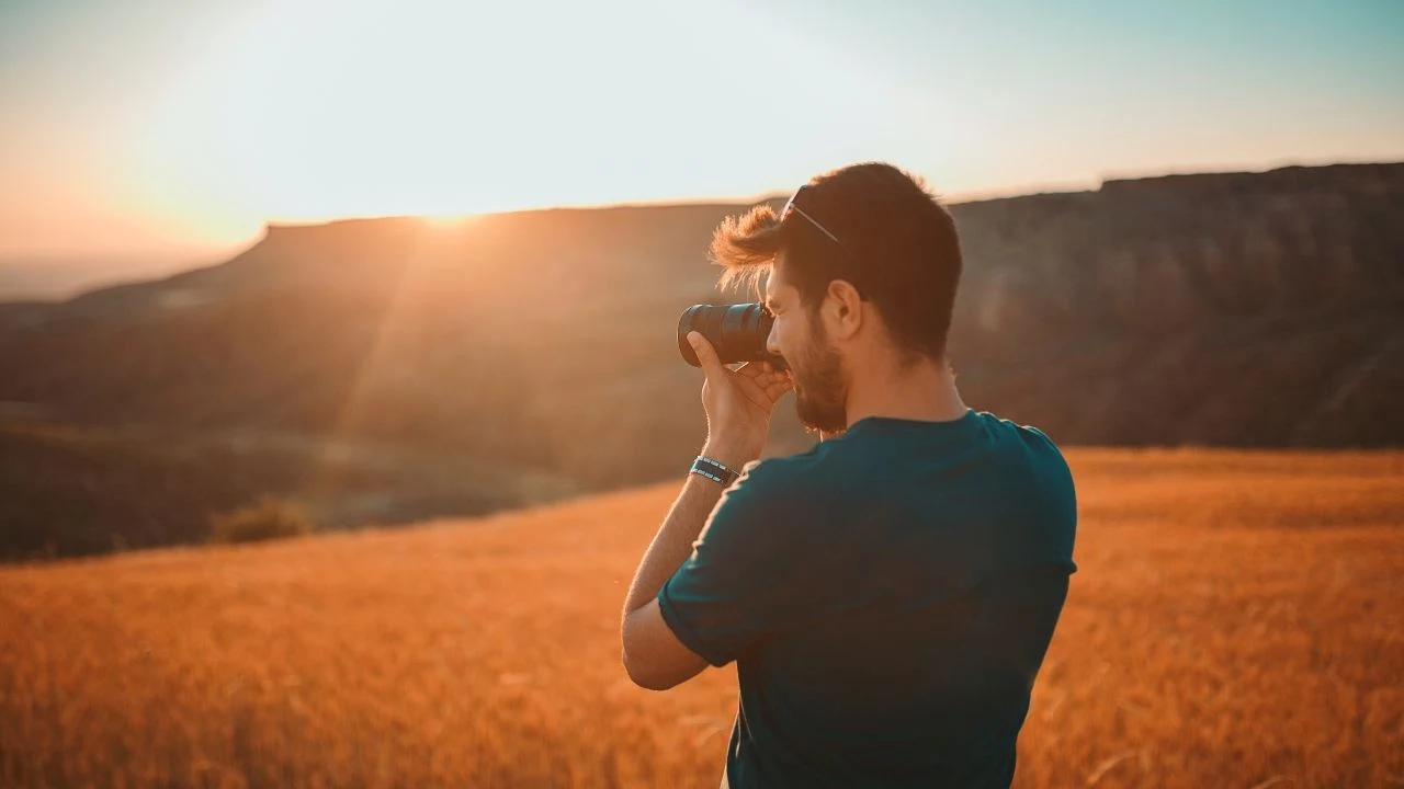 Male photographer documenting sunset.