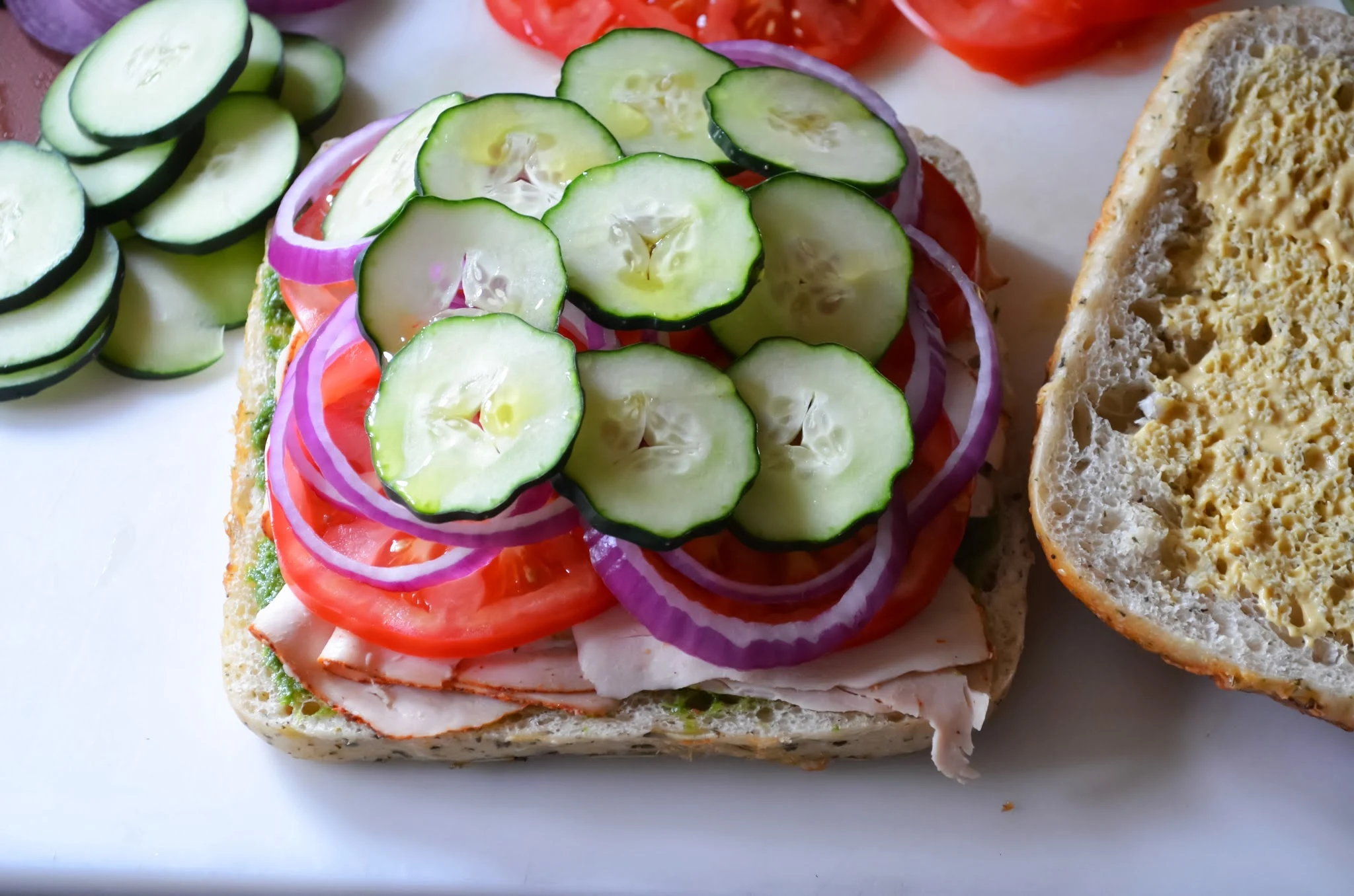 Sliced Cucumbers on top of red onions.