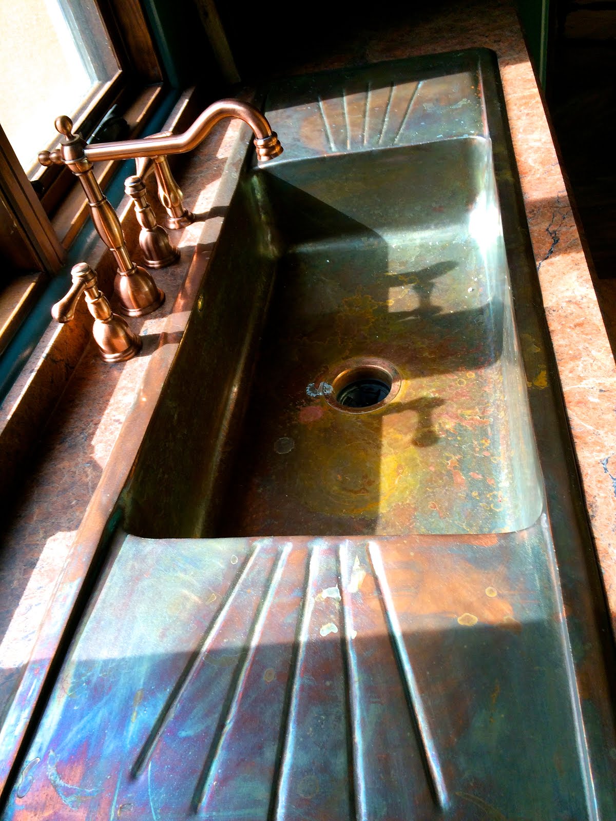 One of a kind copper sink causes kitchen envy.