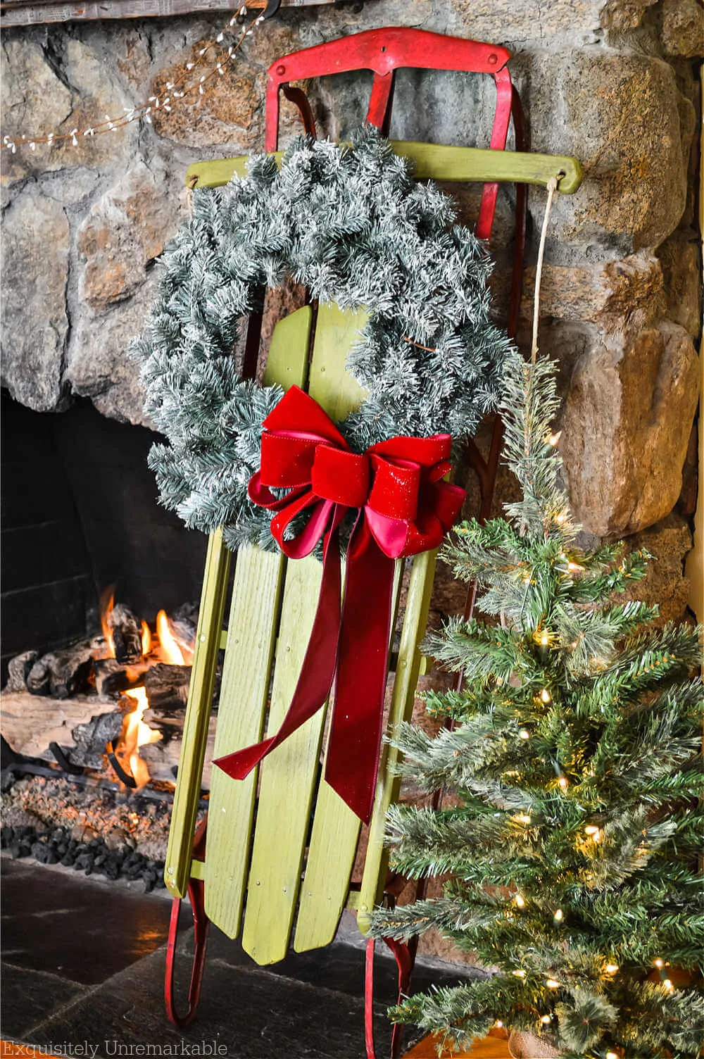 DIY Green and Red Christmas Sled next to the fireplace