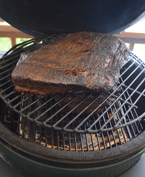 Smoking green chile brisket on a Big Green Egg kamado grill.