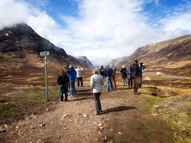 Photo of a group of tourist looking towards Glen Coe