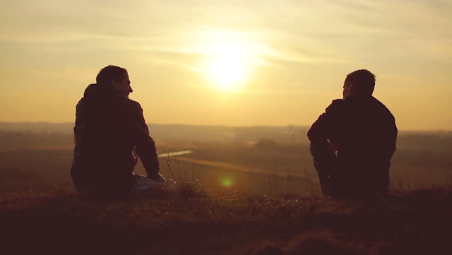 two boys sitting and view of sunset- true friends pictures