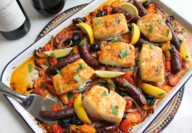 Food Lust People Love: This Spicy Cod and Merguez Traybake is a lovely combination of mild and spicy, flaky and chewy, a tasty way to enjoy both cod and merguez in one dish, not to mention fresh tomatoes and salty olives.