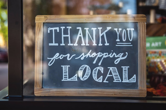 shop local sign on a shop window