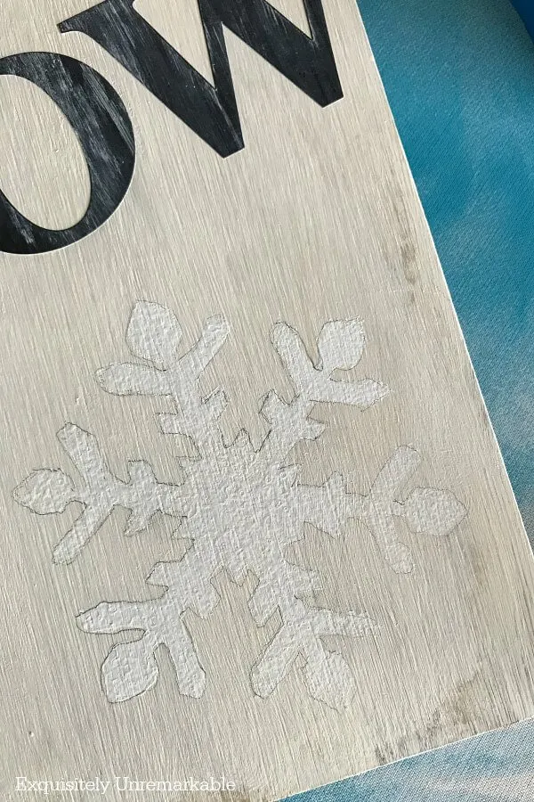 Painting Snowflakes on a board with pencil outlines