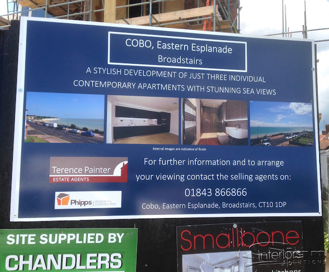 Hoarding sign made for Terence Painter Estate Agents. For the COBO, Eastern Esplanade Broadstairs. The sign has the flowing information 'A stylish development of just three individual contemporary apartments with stunning sea views.' below this is four pictures, showing a sea view from the cliff top, a modern kitchen, a stylish bathroom and another view of the other side of the sea. Below the pictures has information to contact Terence Painter. To the left shows two logos on the sign, Terence Painter Estate Agents and Phipps Property and Construction.