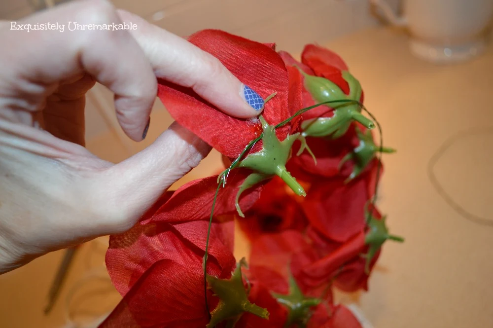 candle rings with flowers and floral wire getting glued onto flowers