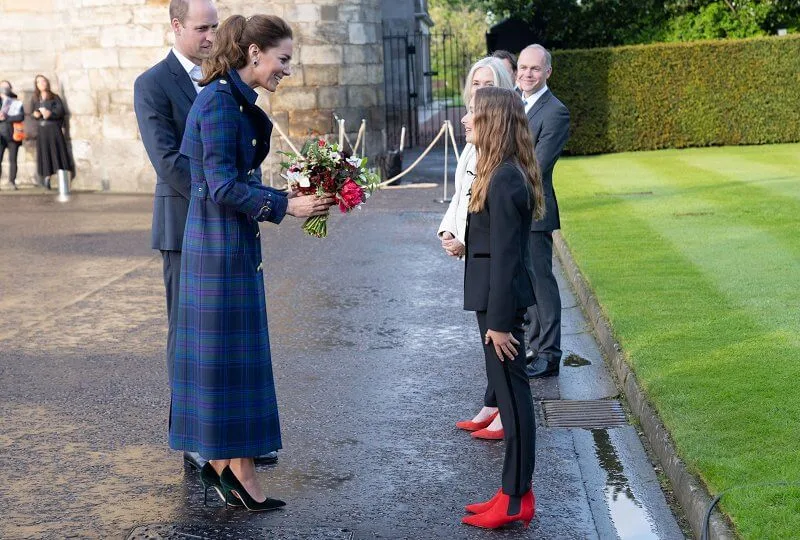 Kate Middleton wore a full length marlborough heather tartan trench coat  from Holland Cooper. Joseph metallic knitted skirt