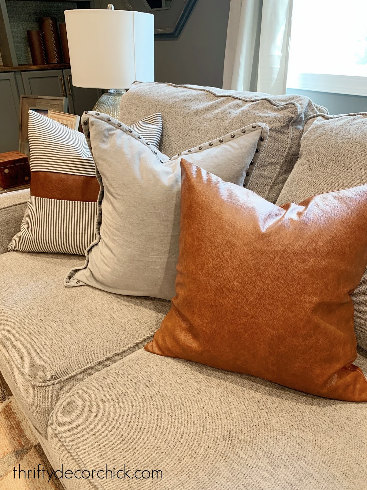 mixing leather and stripe pillow covers