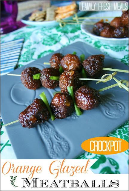 crockpot orange glazed meatballs served on a grey plate