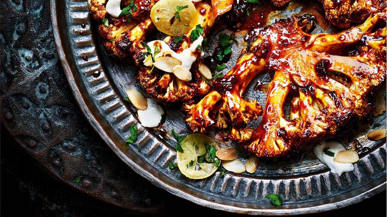 Charred cauliflower steak with tahini, harissa honey sauce and