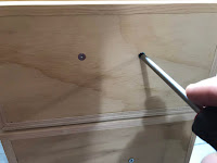 Removing the screws from the drawer pull mounting holes