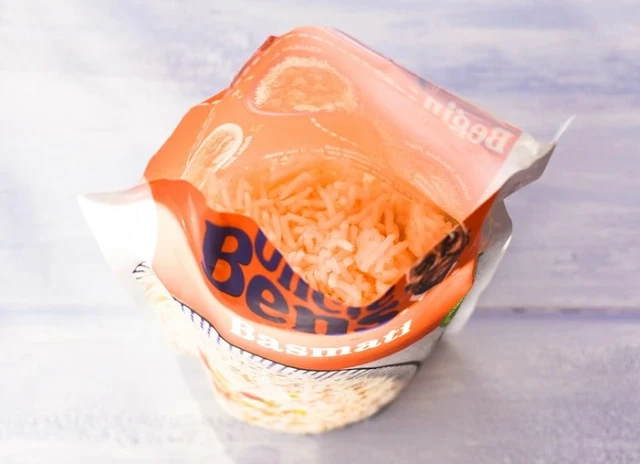 An overhead shot of an open packet of microwave basmati rice