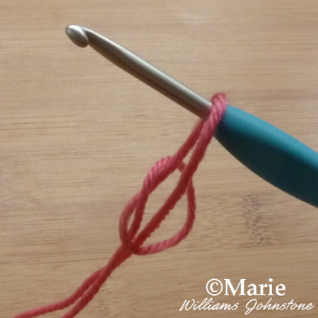 Pulling the slip knot to tighten up around the crochet hook