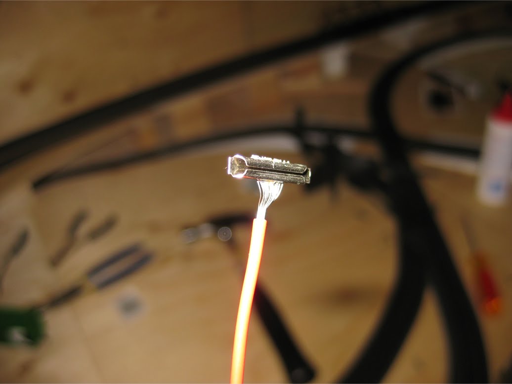 A metal rail joiner soldered to a red power supply wire