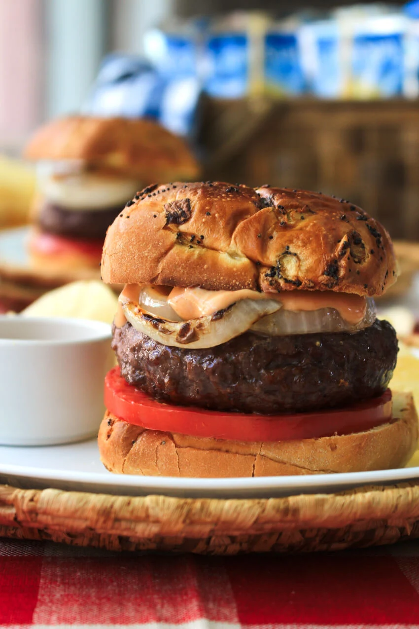 Bacon and Cheese Stuffed BBQ Burgers will be the highlight of your next barbecue!  These juicy burgers stuffed with American cheese and bacon are topped with grilled onions and a zesty barbecue mayo burger sauce.  #ad #burgers #grill @Heinz @Kraft