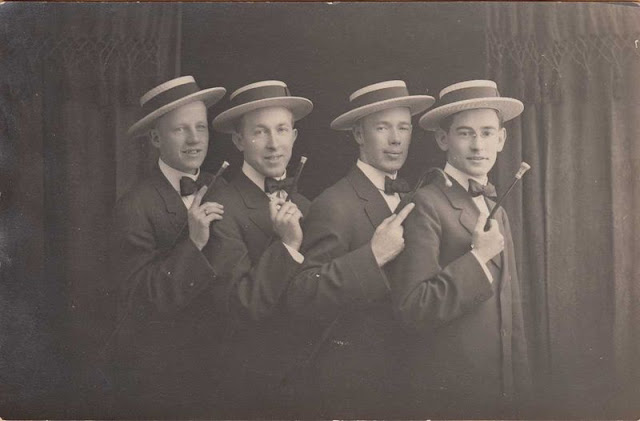 Barbershop Quartet publicity photo c. 1920. Four young men in straw skimmers and bow ties. Standing in front of the curtain. Jingles and other stories of The American Dream. marchmaton.com Barbershop Quartet publicity photo c. 1920. Four young men in straw skimmers and bow ties. Standing in front of the curtain. Jingles and other stories of The American Dream. marchmaton.com