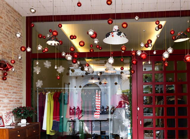 Christmas-themed storefront display of a clothing boutique.