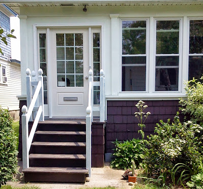 Front stoop with white door and white railings before the door was painted white