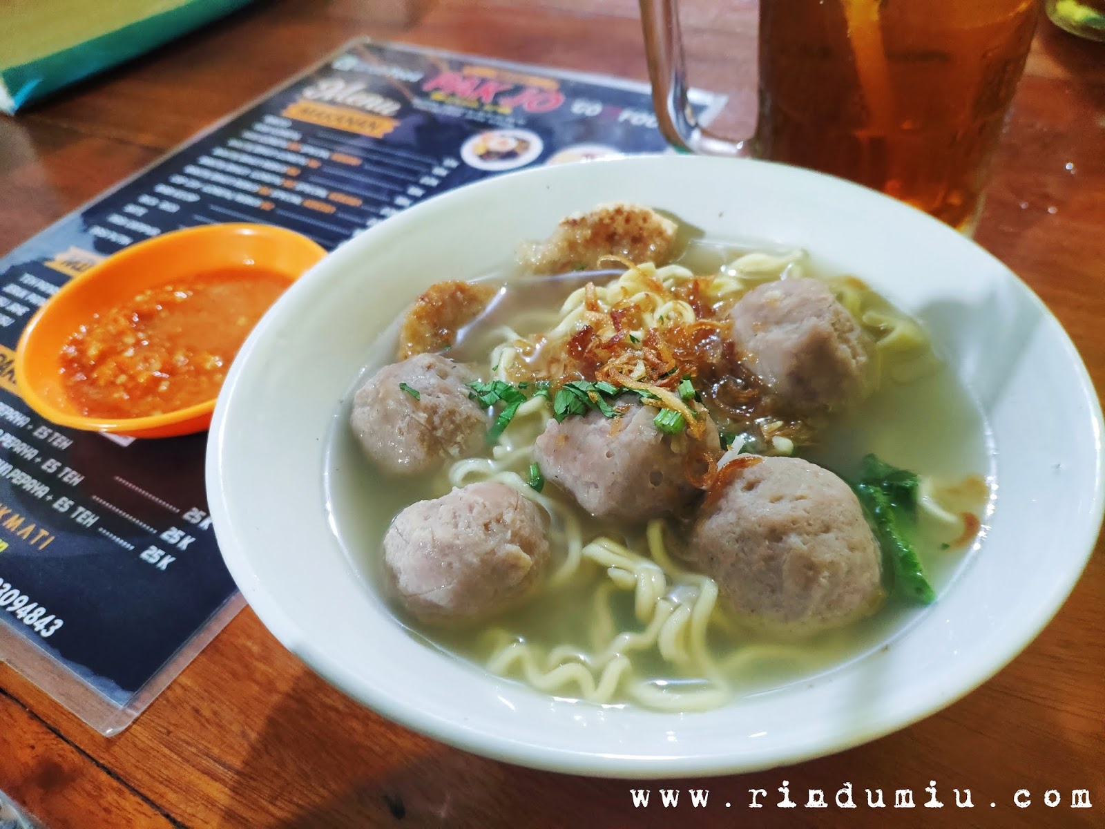 a bowl of pork meatballs soup with chili