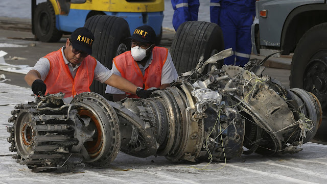 Officials inspect an engine recovered from the crashed Lion Air jet in Jakarta, Indonesia