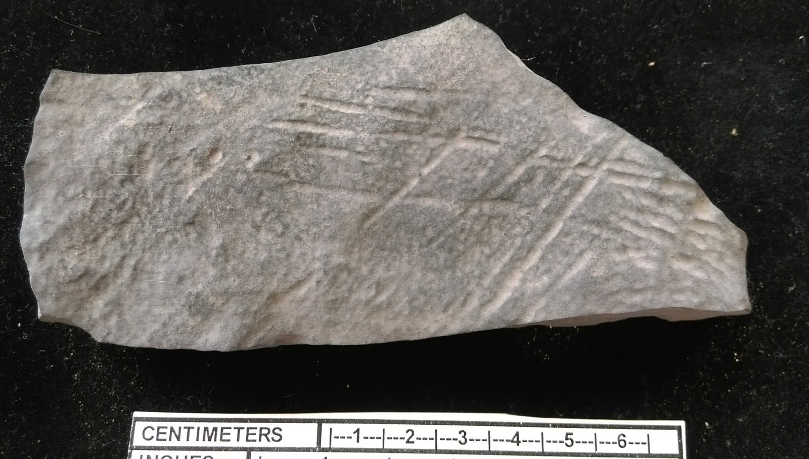 Archaeology of Portable Rock Art Arkfeld Site carved grid on a