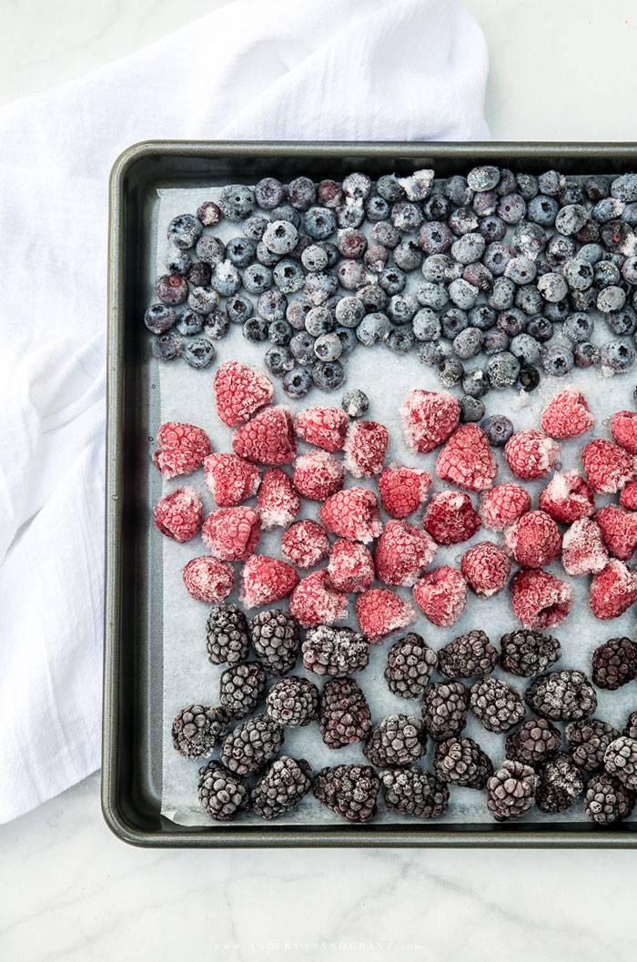Have fresh berries all year long for recipes like muffins and pies by freezing raspberries, blackberries, and blueberries when they are fresh. Learn the technique at www.andersonandgrant.com Freezing berries on a baking sheet
