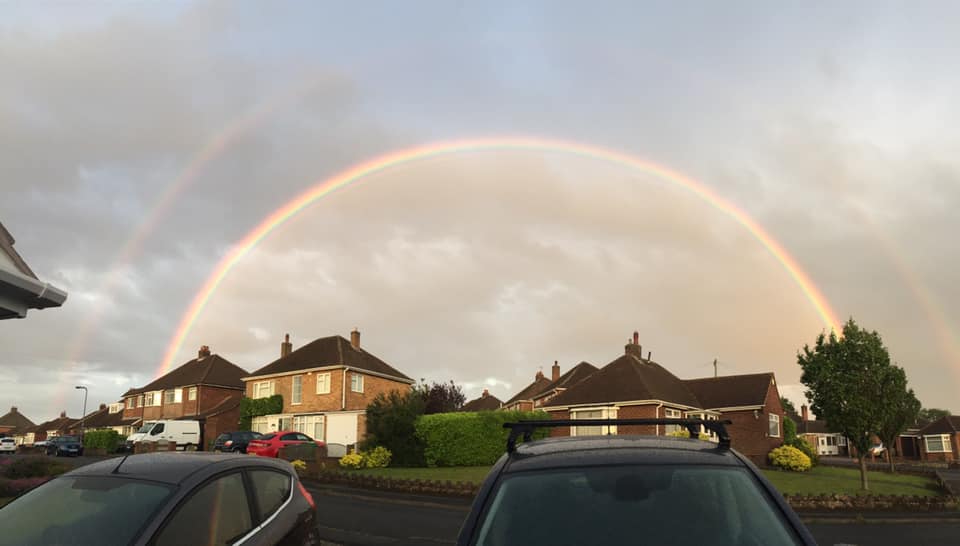 rainbow over houses