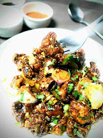 Serving chilli mushroom in a plate with spoon