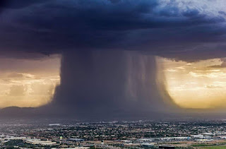 A large, black mushroom shaped cloud dumping water on an AZ city. Monsoon 7-17-14. Photo by L. Markley