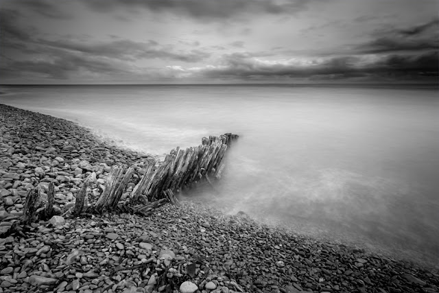 Black and white image of beach groynes at Porlock Weir by Martyn Ferry Photography