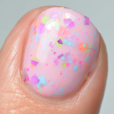 pink nail polish with glitter close up swatch