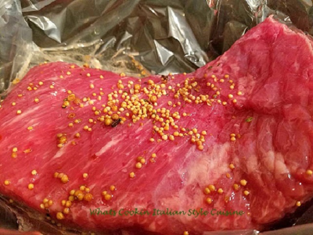 this is a raw piece of corned beef in a slow cooker with seasoning packet added
