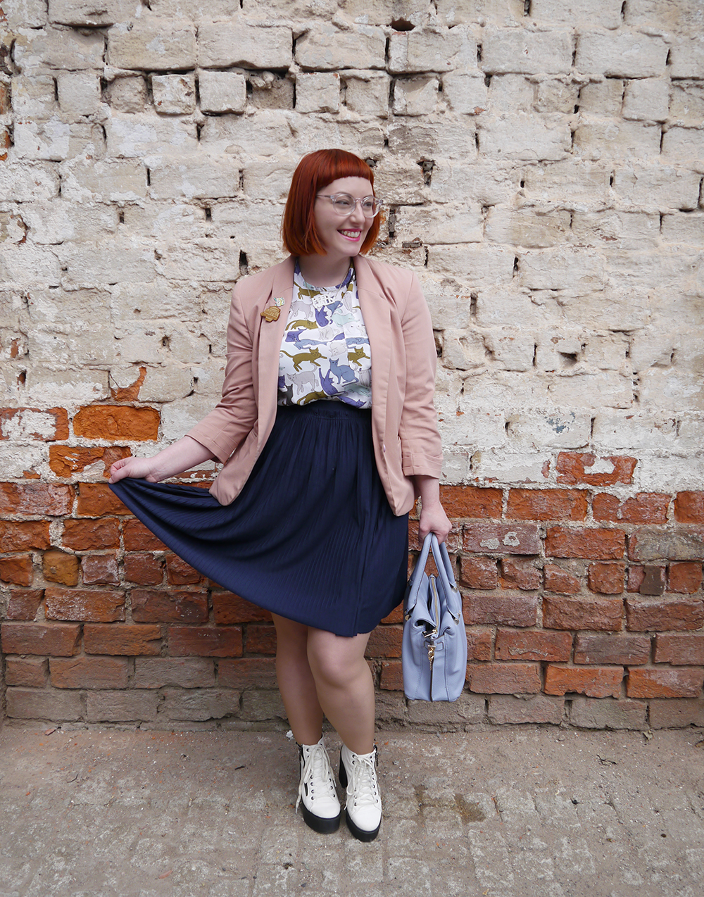 H&M Highstreet outfit what Helen wore, red head, See with Iolla, Iolla clear glasses, clear spectacles, Scottish blogger, scottish fashion blogger, Dundee blogger, Dundee event, Dundee, cat lady, crazy cat lady outfit, cat top, H&M outfit, blue skirt, pleated navy skirt, charity shop shoes, white lace up boots, pink blazer, Lucky Dip Club pin, Kate Rowland wooden brooch, Bonnie Bling necklace, Scottish slang necklace, peely wally necklace, Scottish street style, brick wall background, cat print top
