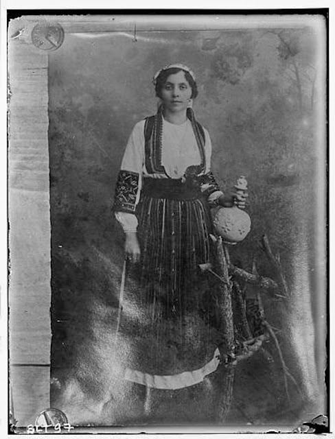 Reproduction of a photographic print of a Macedonian woman posing with a jug, village Negochani (Niki)