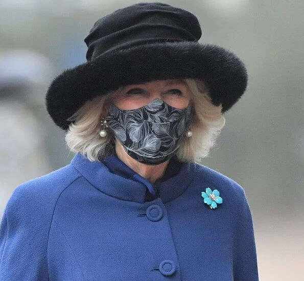 The Duchess of Cornwall wore a blue wool coat, and wears a face mask