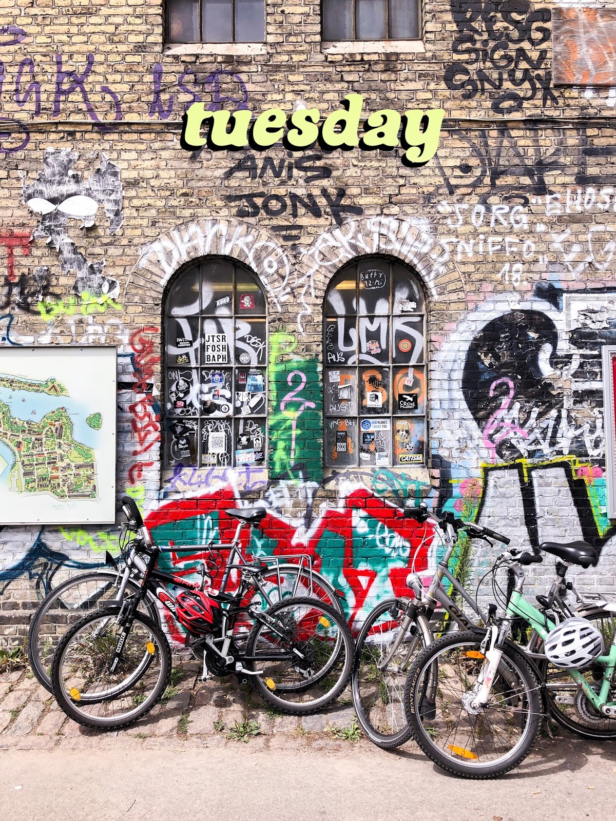 bikes against graffiti wall in Christiania, Copenhagen