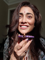 Shriya Saran (Indian  Actress) Wiki, Bio, Age, Height, Husband, Movies, Awards and Many More Shriya Saran holding Lamp