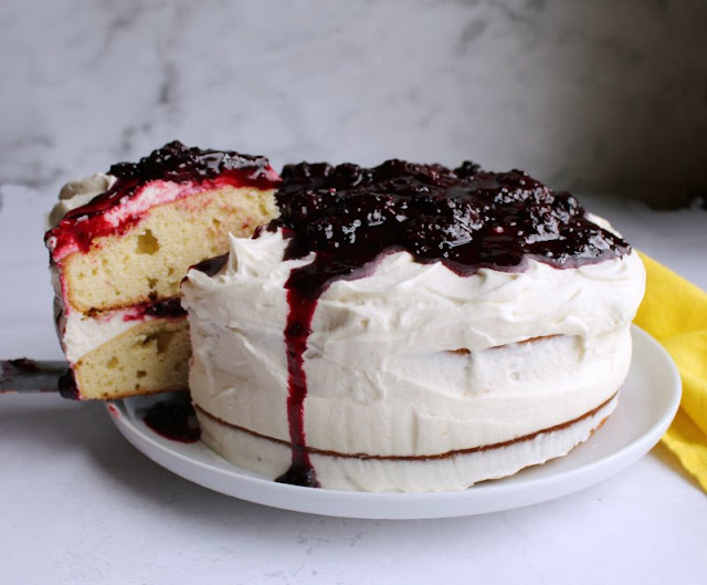 Instead of making individual shortcakes for everyone, make one big blackberry shortcake cake. It is a beauty to make and serve and it tastes delicious too. With layers of slightly sweet biscuity cake, fluffy vanilla frosting and plenty of blackberries to go around, it is a sure winner. whole blackberry shortcake cake with first slice being removed
