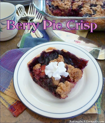 Berry Pie Crisp is a summertime favorite. An assortment of berries, mixed with a bit of toffee and baked as a pie, crisp hybrid. | Recipe developed by www.BakingInATornado.com | #recipe #pie