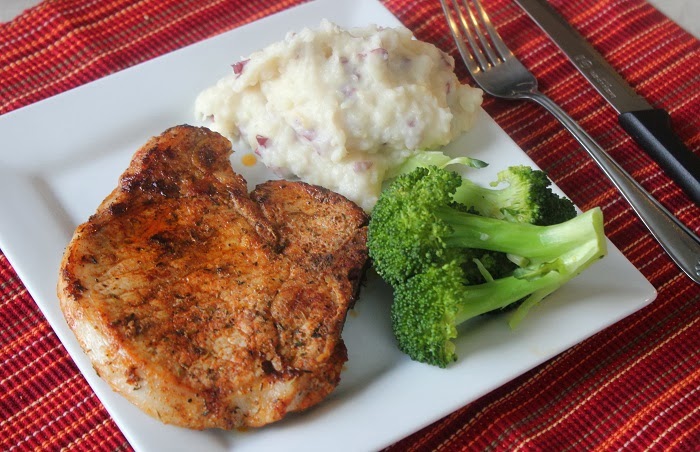 plate with pork chop, broccoli and potatoes