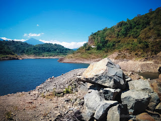 Ground Rock Fragments The Hills And Lakeside Water Titab Ularan Dam On A Sunny Day In The Dry Season North Bali Indonesia