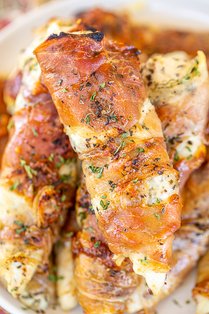 Low-Carb Prosciutto Wrapped Chicken - dangerously delicious! So simple to make with only 4 ingredients. Chicken, Italian seasoning, mozzarella cheese, and prosciutto. Ready to eat in 20 minutes! We make these at least once a month. Great with pasta, risotto, or asparagus for a Keto and low-carb friendly meal. #keto #lowcarb #glutenfree #chicken #prosciutto prosciutto wrapped chicken tenders