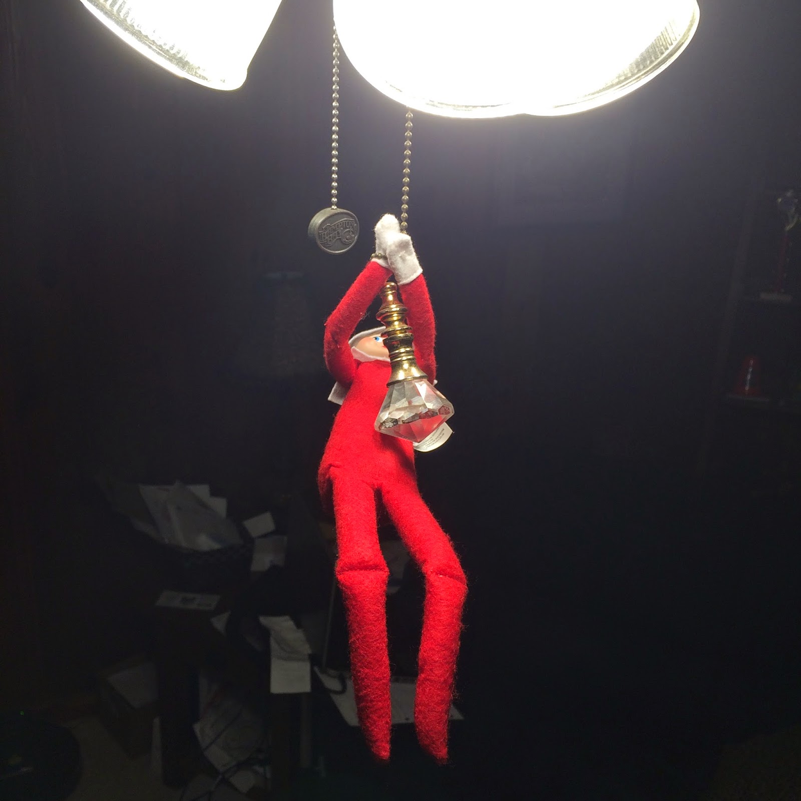 Elf on the Shelf pulling ceiling fan chain