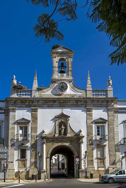 The top of the arch of Arco da Vila includes a clock and bell