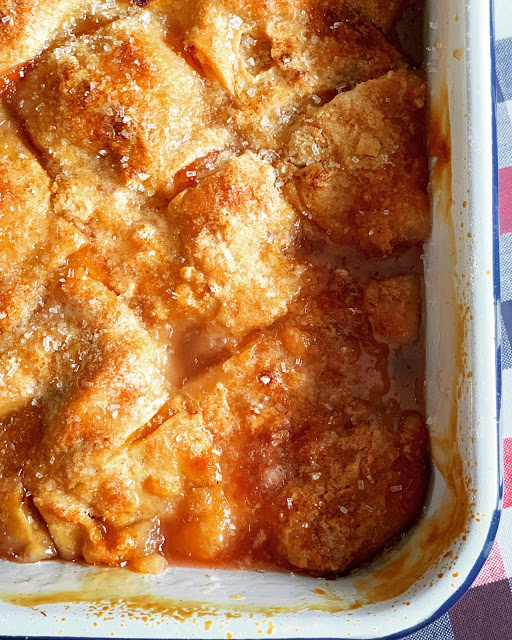 This photo shows Peach Dumpling Cobbler after baking in a baking dish. 