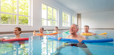 Seniors in pool exercising